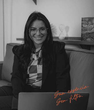 Kamila Santos sorrindo, sentada com o notebook
